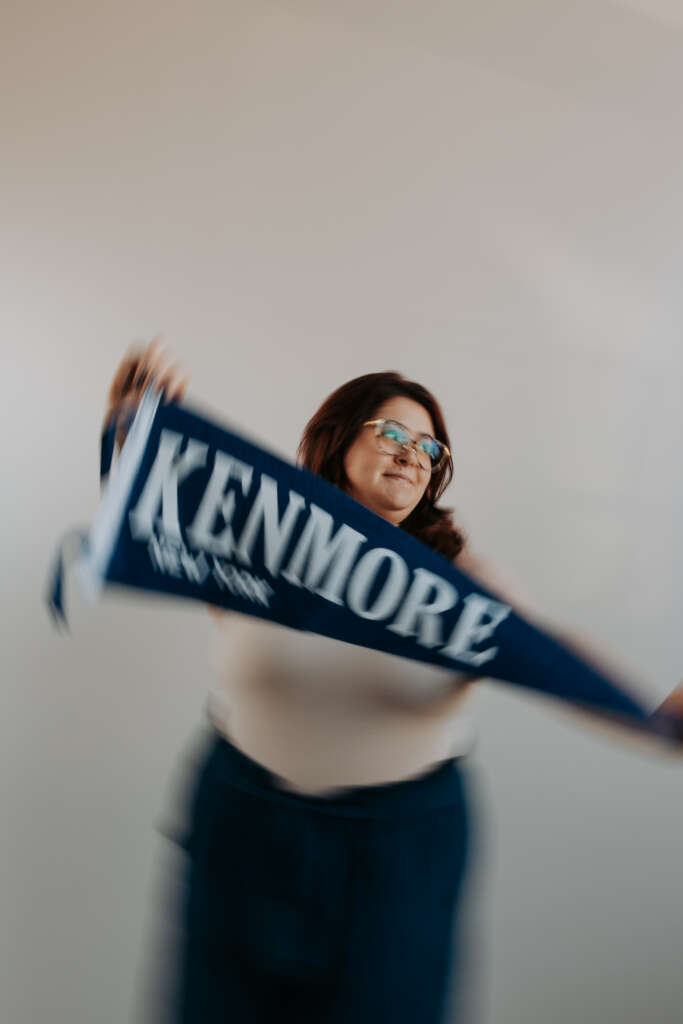 Rebecca Nagel holding a Kenmore pennant